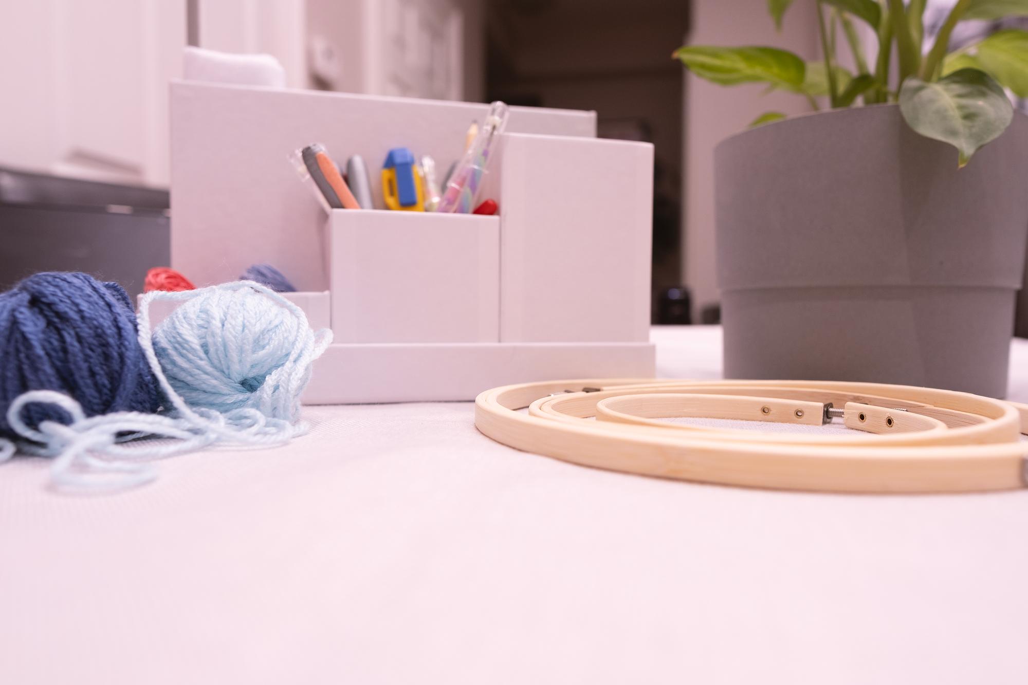 Student workspace with threads and hoop